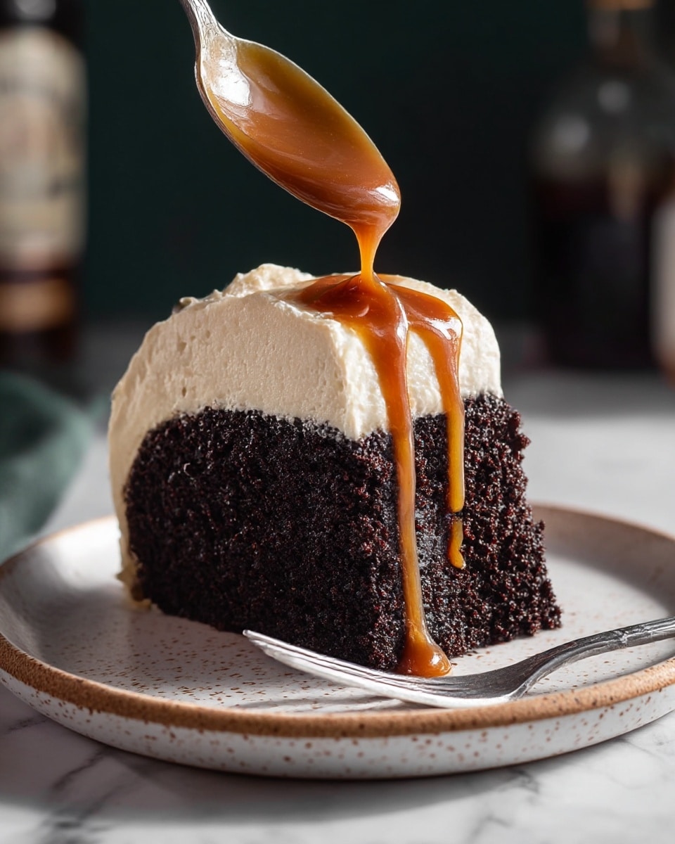 A slice of dark chocolate cake sits on a white plate with light brown speckles, showing one thick bottom layer of moist, dense chocolate cake with a smooth, creamy white frosting layer on top. A spoon held above the cake drizzles rich, glossy caramel sauce in a thick stream onto the frosting, some sauce dripping down the sides of the cake. A silver fork rests on the plate in front of the slice, and the background is softly blurred with dark tones and hints of bottles. The surface beneath the plate is a white marbled texture. Photo taken with an iphone --ar 4:5 --v 7