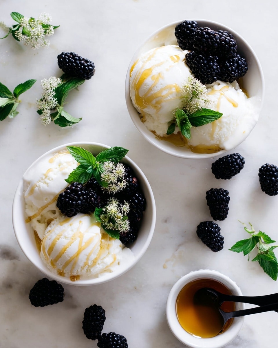 The image shows two white bowls filled with three large scoops of white vanilla ice cream, each scoop drizzled with a golden honey syrup. On top of the ice cream, one side is decorated with glossy, deep black blackberries, and a fresh sprig of green mint with small white flowers is placed on the center scoop, adding a touch of bright green and delicate detail. Around the bowls, scattered shiny blackberries lie on a white marbled surface, along with sprigs of mint. A small white bowl containing more honey syrup with a black spoon is also visible on the right. The whole scene is bright, fresh, and neatly arranged with a clean and natural look. photo taken with an iphone --ar 4:5 --v 7
